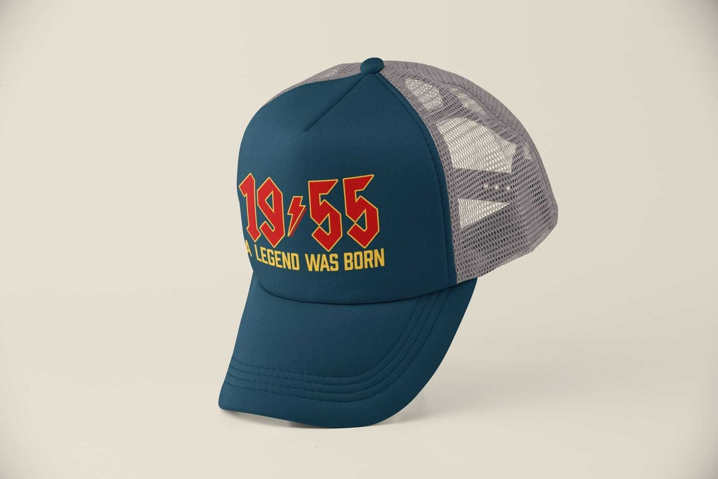 70th birthday trucker cap with "1955 A Legend Was Born" text in retro rock font, mesh back, adjustable fit.