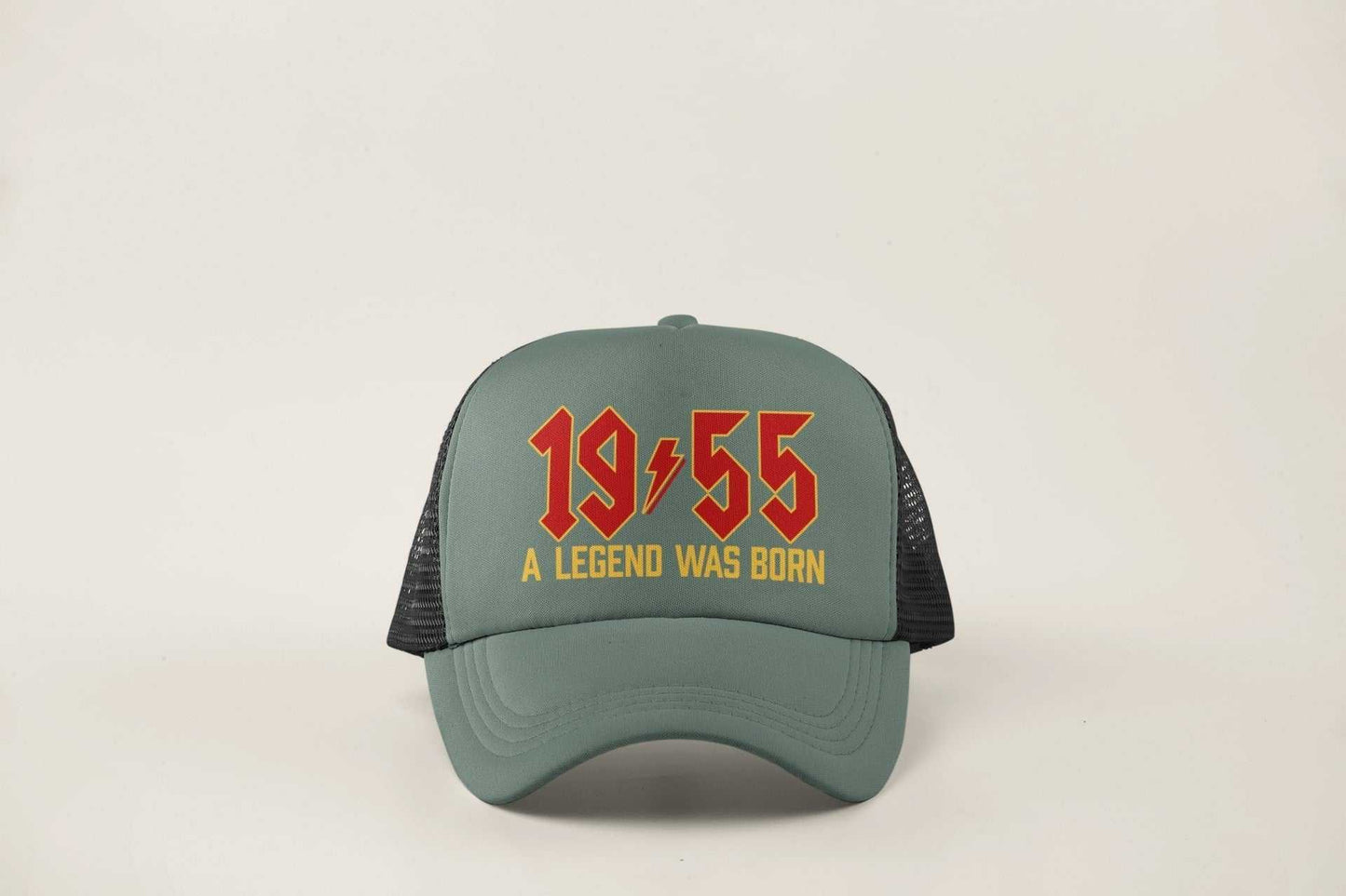 70th Birthday Gifts 2025 Trucker Cap with "1955 A Legend Was Born" design in retro rock font, mesh back, adjustable fit.