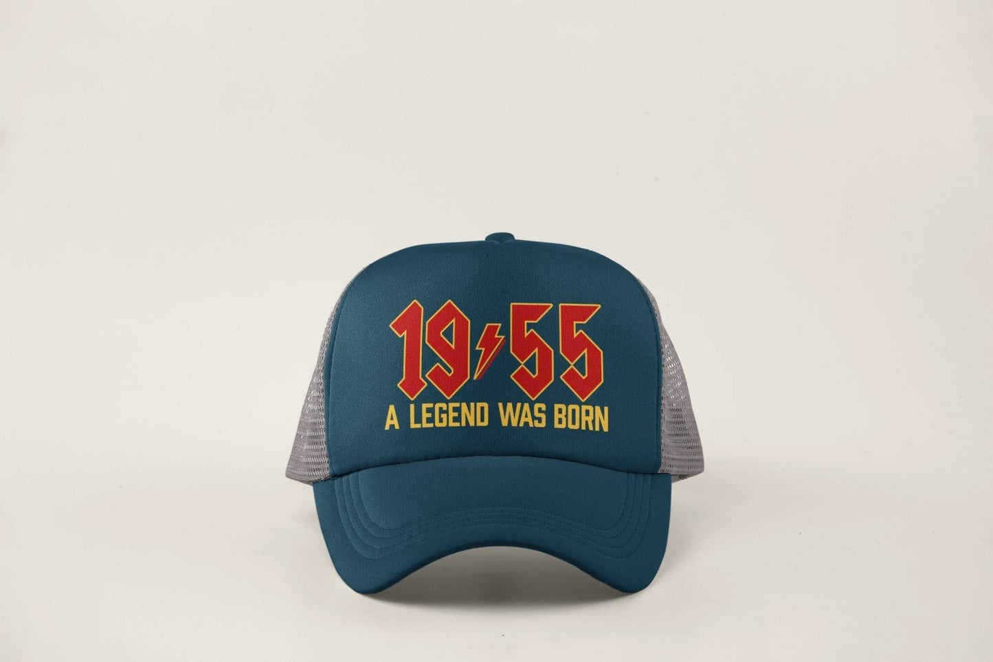 70th Birthday Gifts 2025 Trucker Cap with "1955 A Legend Was Born" in retro rock font, navy front and mesh back.