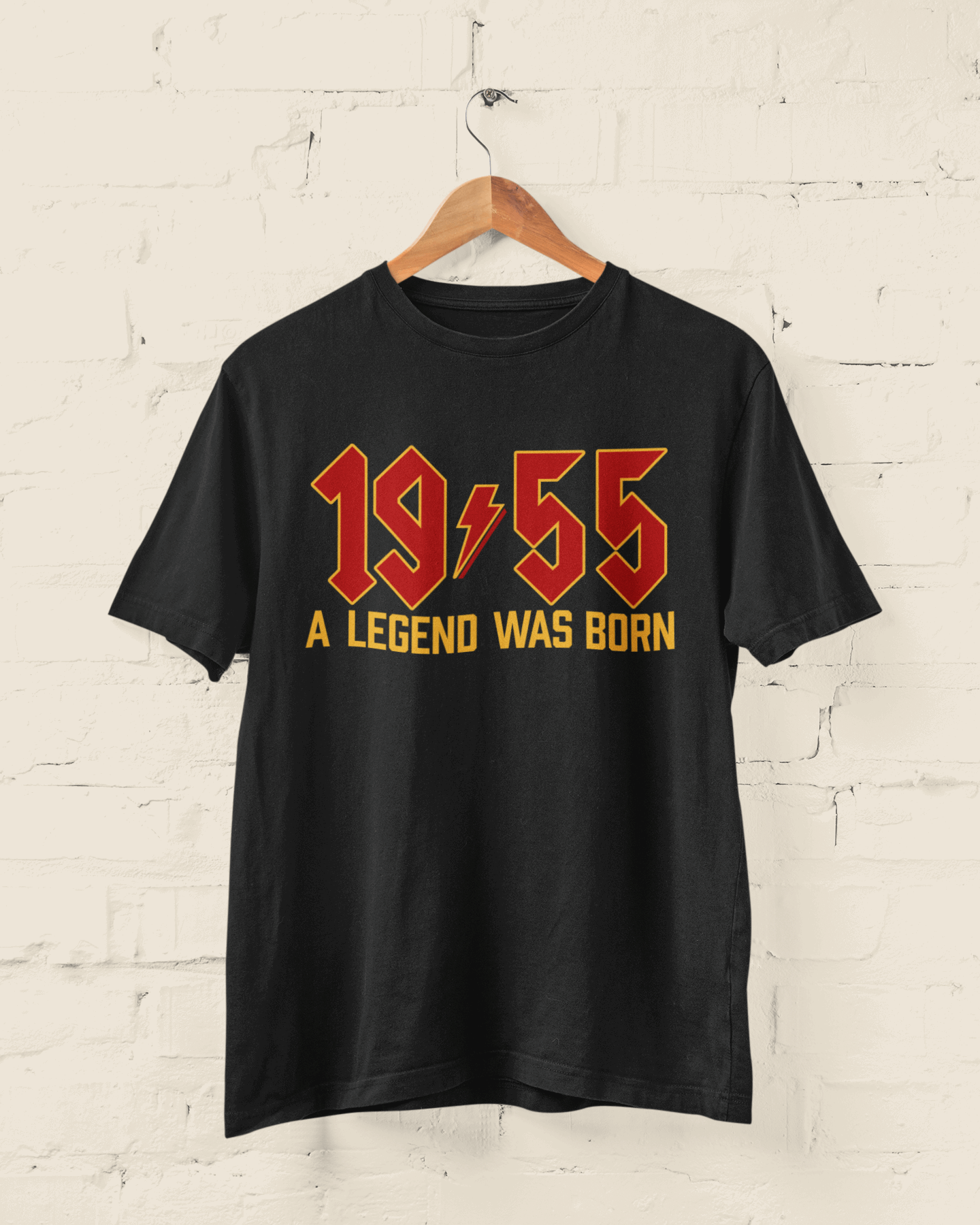 70th birthday t-shirt with "1955 A Legend Was Born" in retro heavy metal font on a black background.