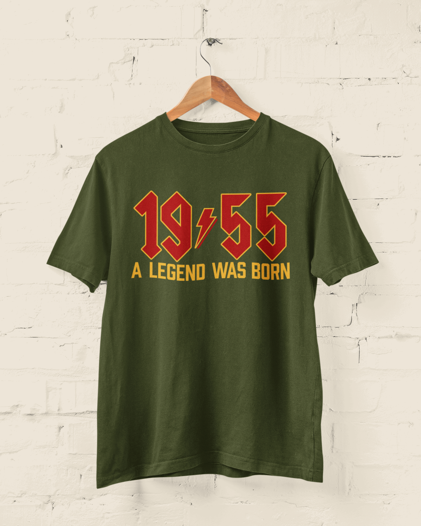 70th birthday t-shirt with "A Legend Was Born in 1955" in retro heavy metal font on display.