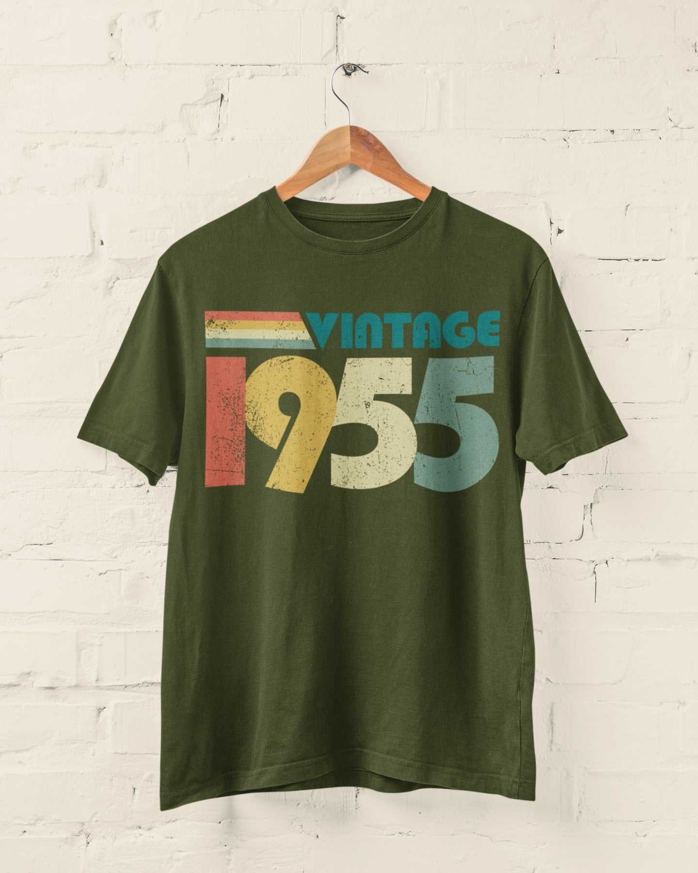 Vintage 1955 retro style t-shirt on wooden hanger against white brick wall.