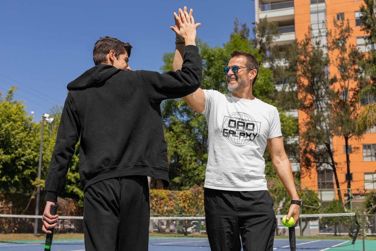 "Best Dad in the Galaxy" t-shirt for Father's Day or Christmas gift, worn during a tennis match.