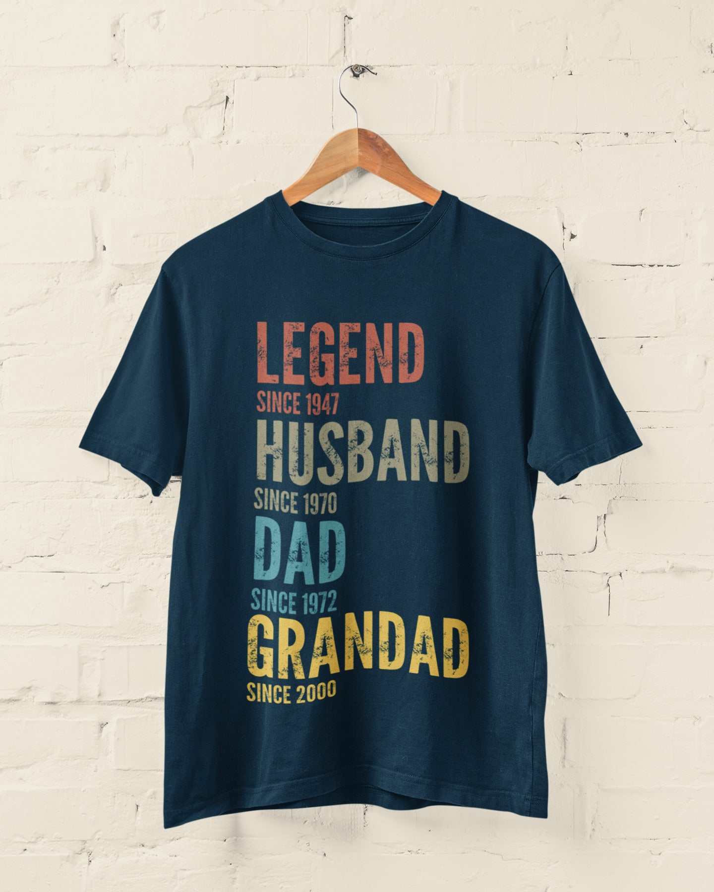 Personalised Grandad, Dad, Husband, Legend T-Shirt hanging on hanger with customisable text for family milestones.