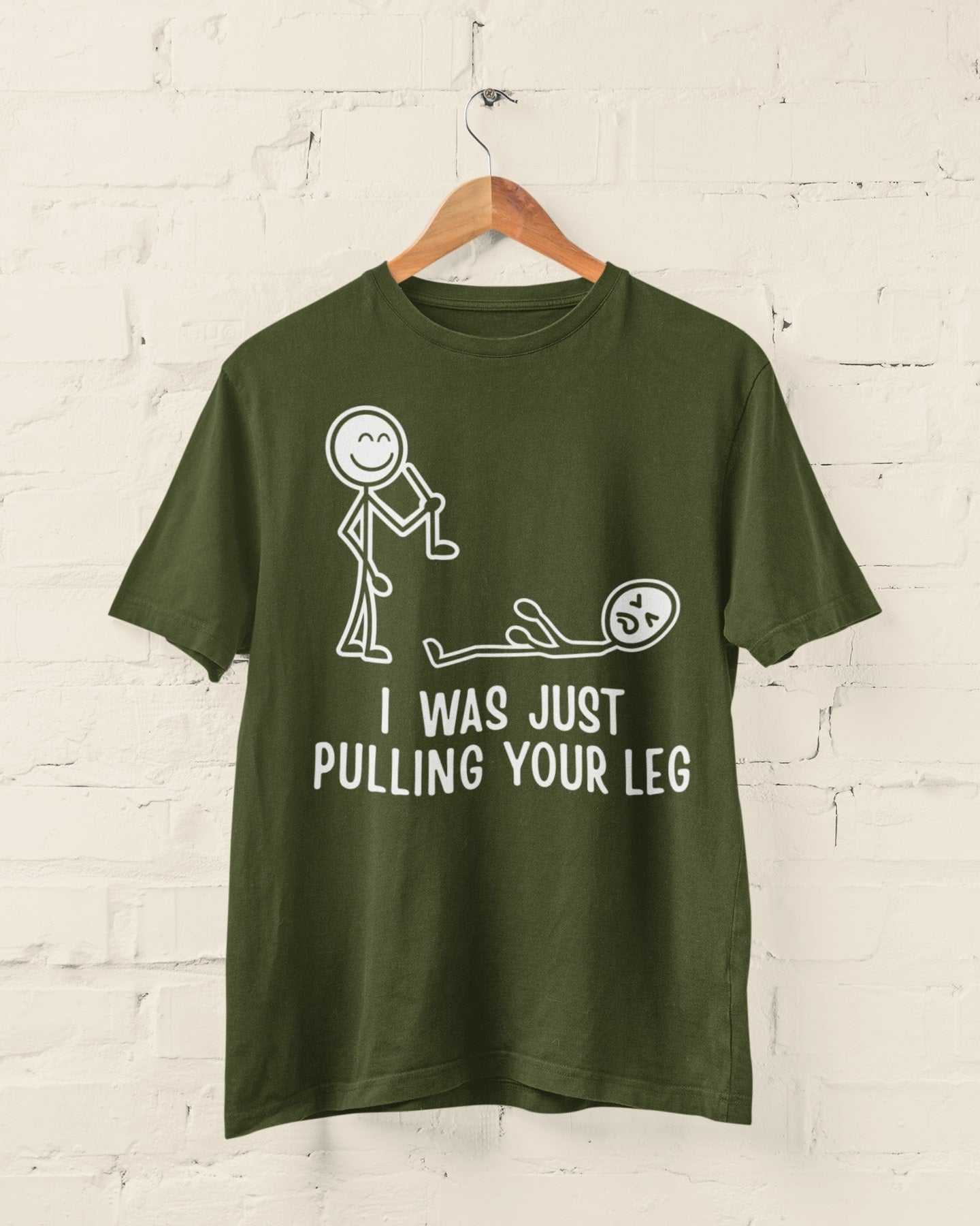 Funny stick figure joke t-shirt with "I Was Just Pulling Your Leg" design on a hanger.