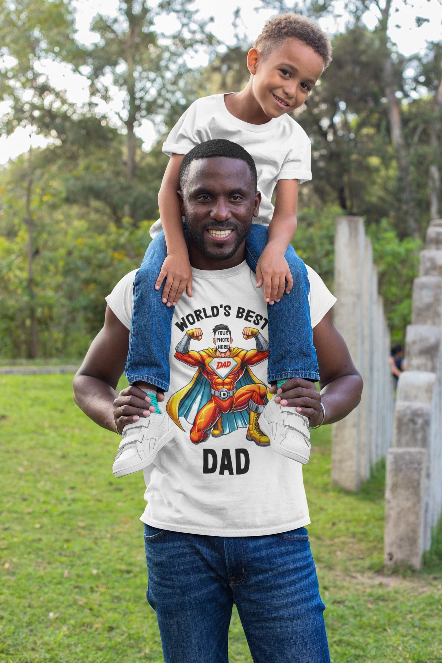 Father and son smiling, wearing personalized superhero dad t-shirts with custom face design, outdoors.
