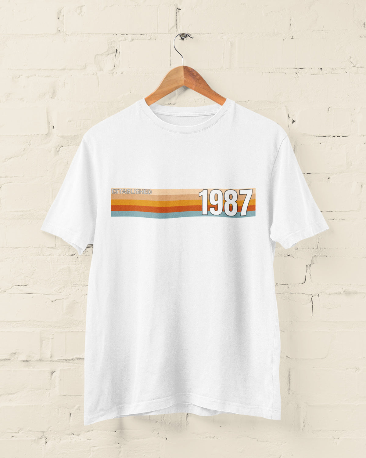 White Established 1987 vintage strip T-shirt hanging on a wooden hanger