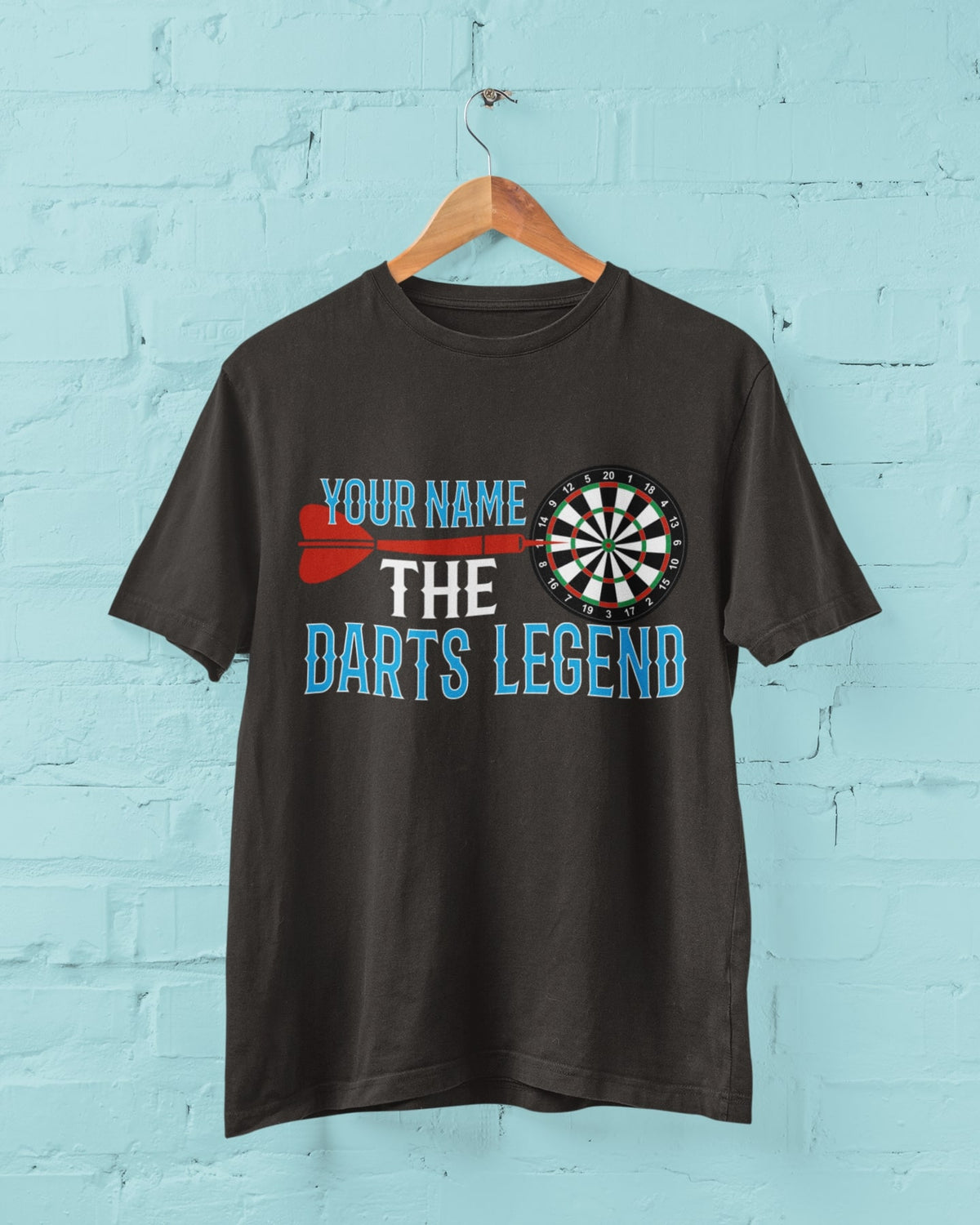 Personalised The Darts Legend custom name T-shirt displayed hanging on a wall
