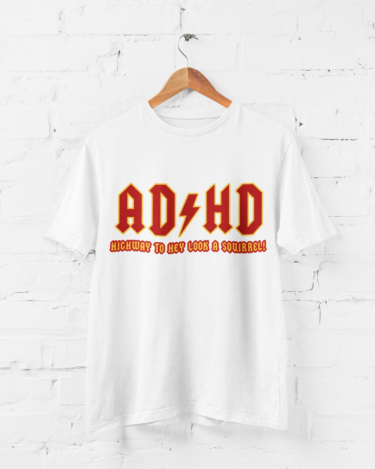 ADHD Highway to Hey Look a Squirrel graphic T-shirt displayed hanging on a wall